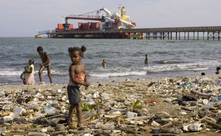Haina, Dominican Republic; Photograph: Eduardo Munoz/Reuters Garbage-A-girl-stands-on--021